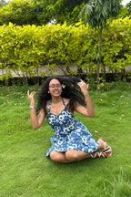 Ami indigo floral halter mini dress with flared skirt in motion