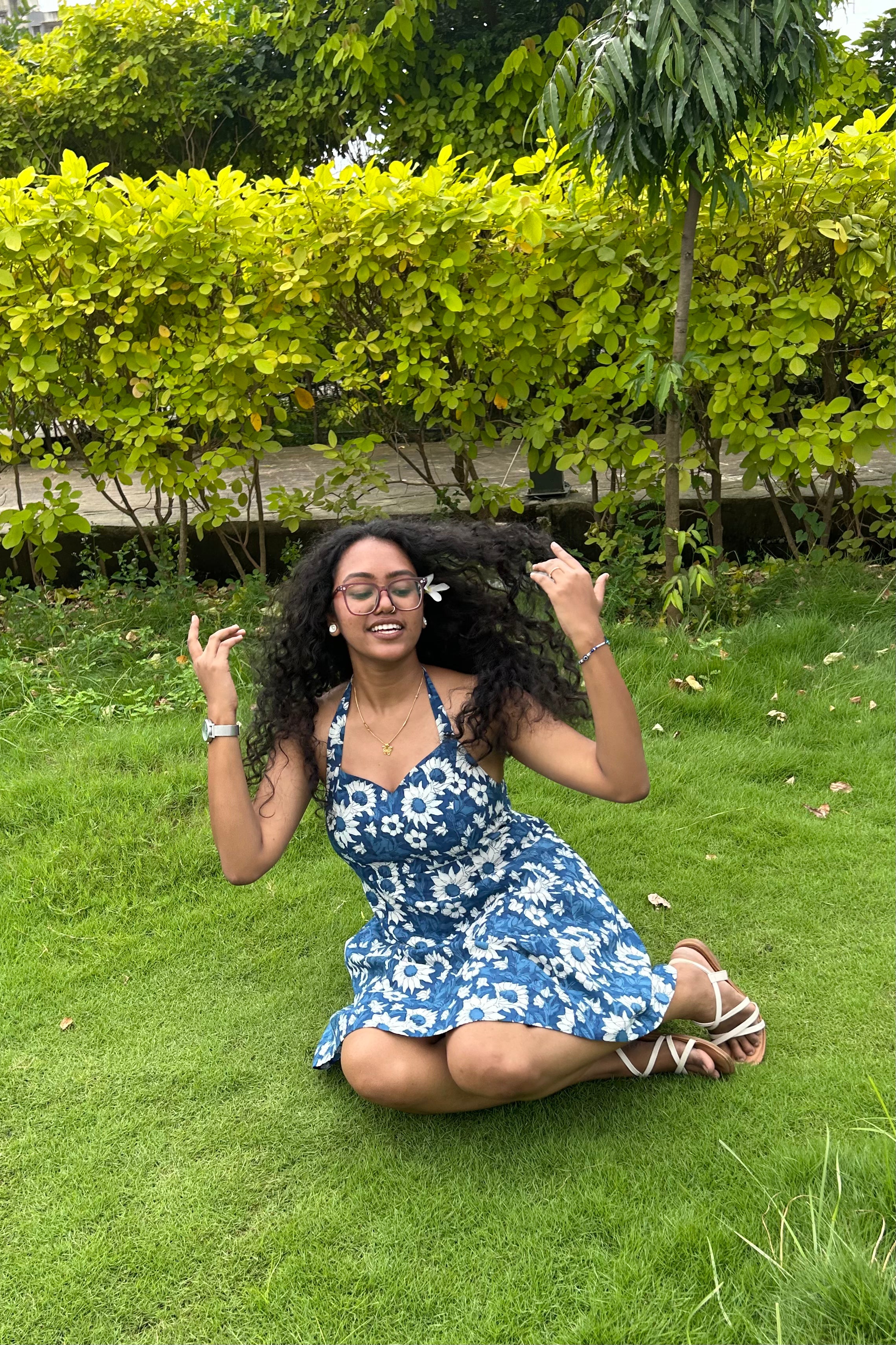 Ami indigo floral halter mini dress with flared skirt in motion