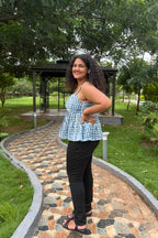 Tia indigo peplum top styled with black jeans