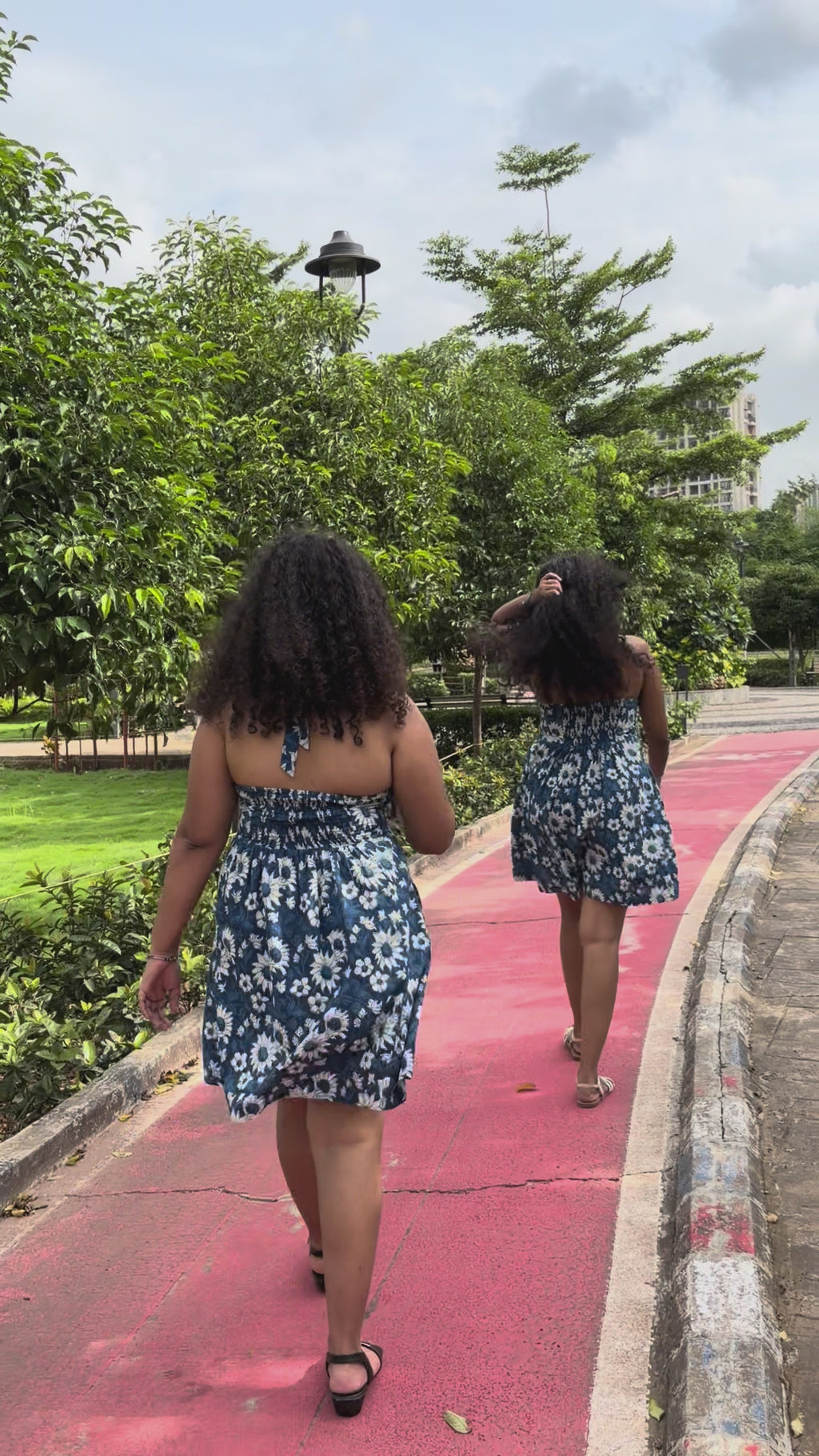 Ami indigo floral halter mini dress with flared skirt in motion